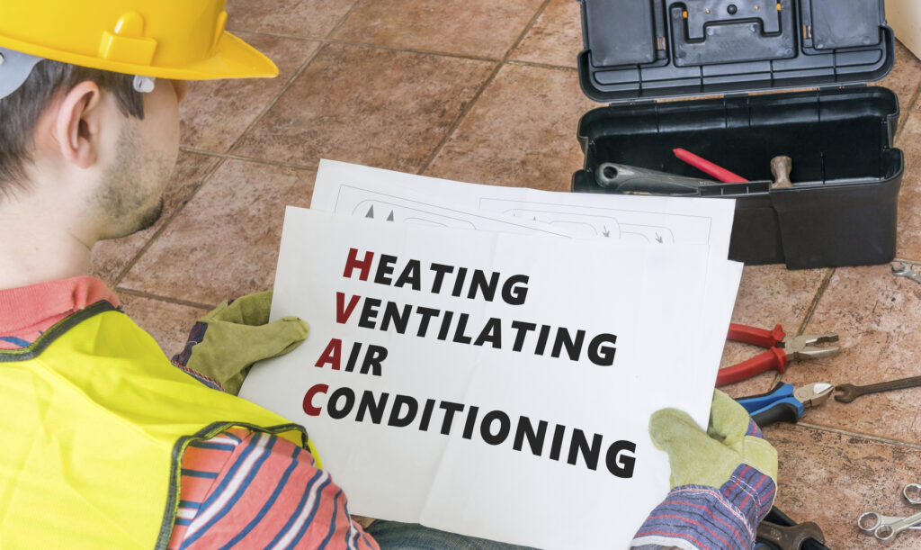 Worker displaying HVAC acronym breakdown in safety attire, ideal for training, branding, or service promotion.
