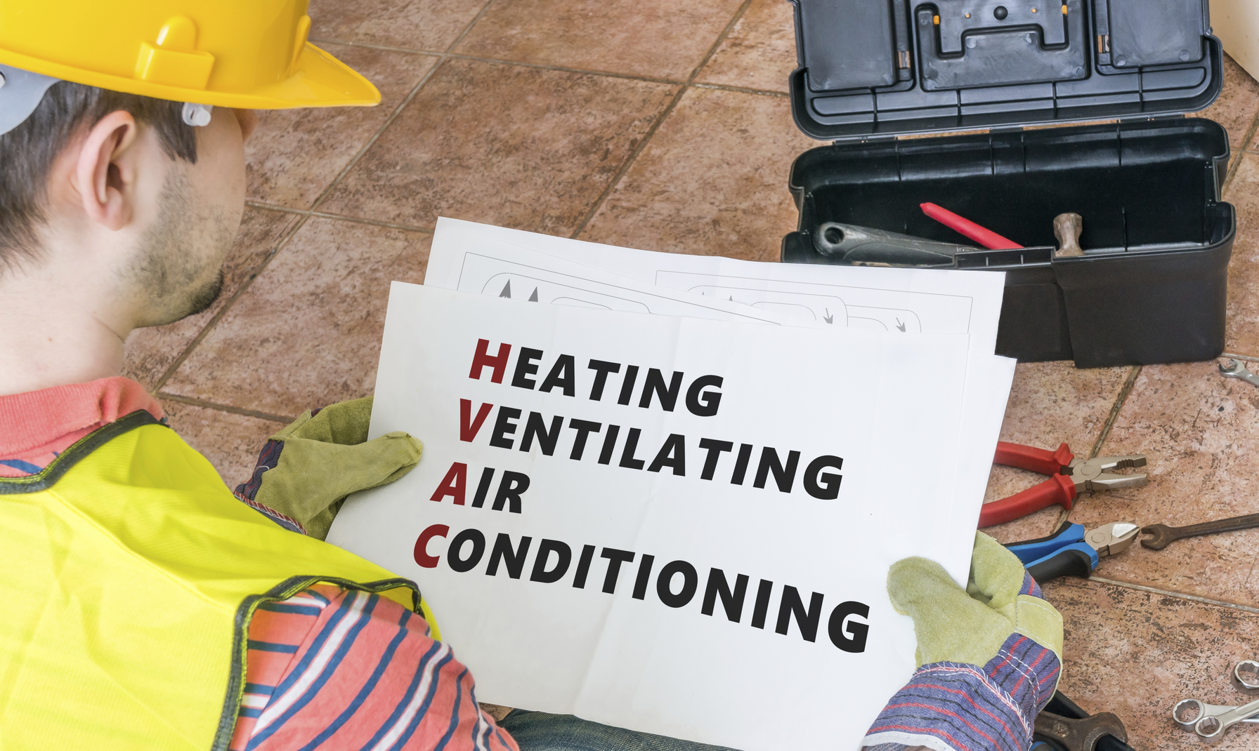 Worker displaying HVAC acronym breakdown in safety attire, ideal for training, branding, or service promotion.