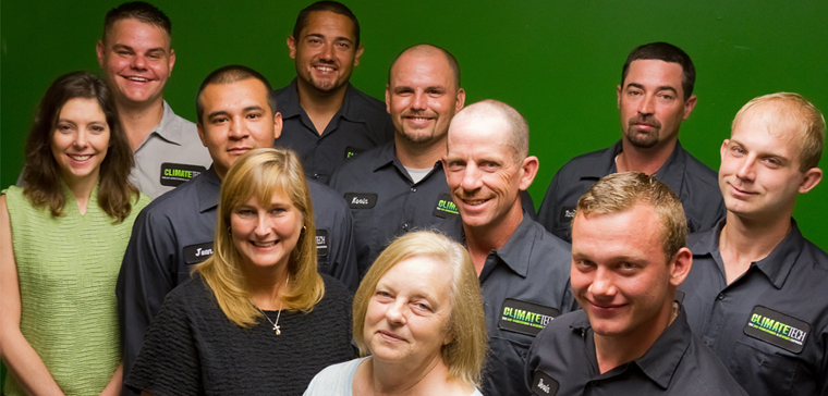 ClimateTech team featuring uniformed technicians and casually dressed staff in company group photo.