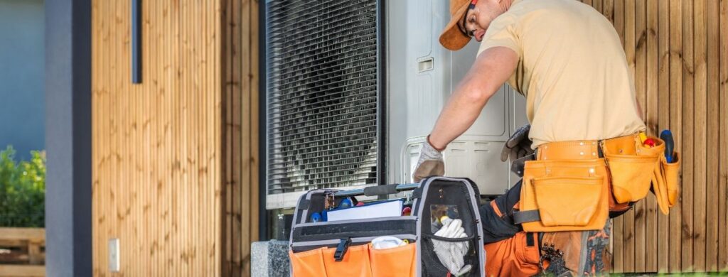 An HVAC Technician working on a heat pump.