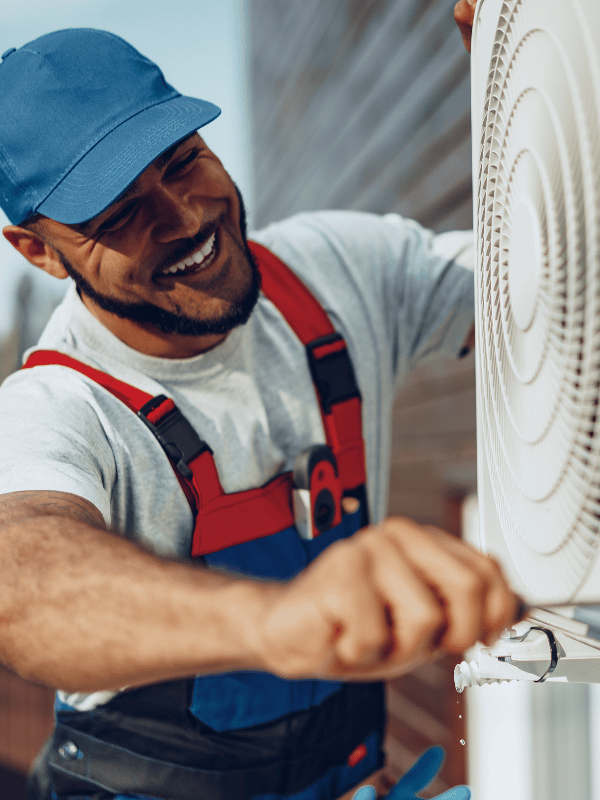 A man installing an air conditioning unit.