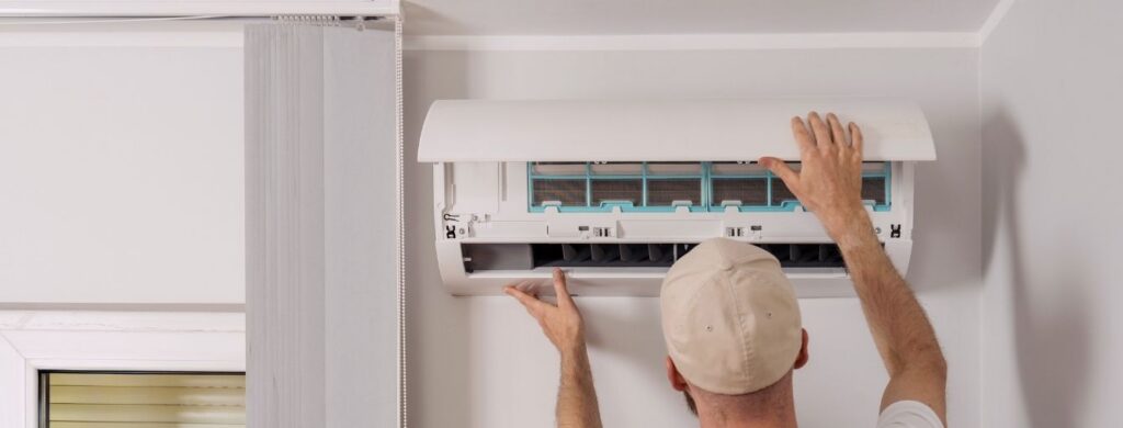 An HVAC technician repairing an air conditioning unit.