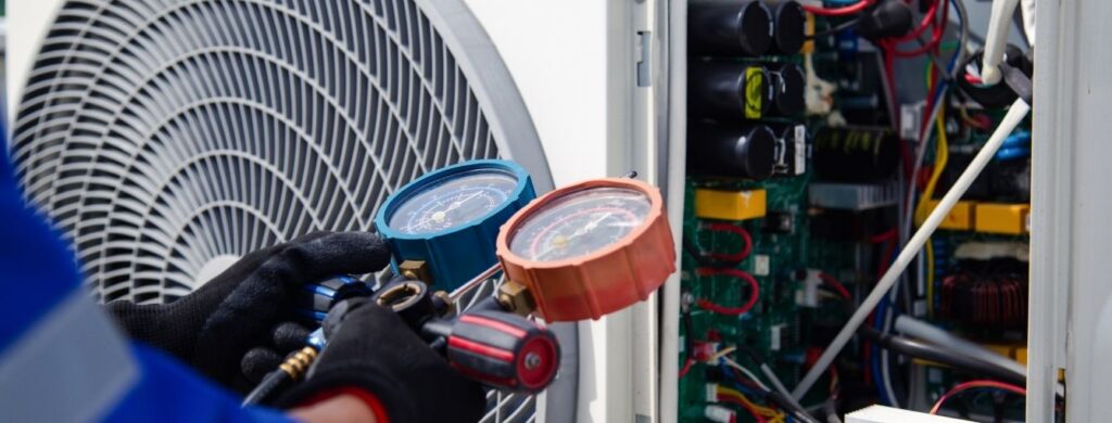 An HVAC technician working on a commercial HVAC Unit. 