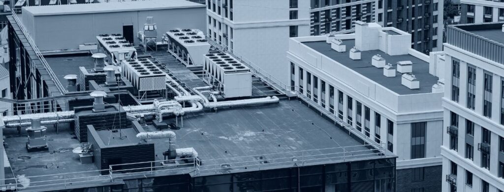 An overview of an apartment building with HVAC units on the roof. 