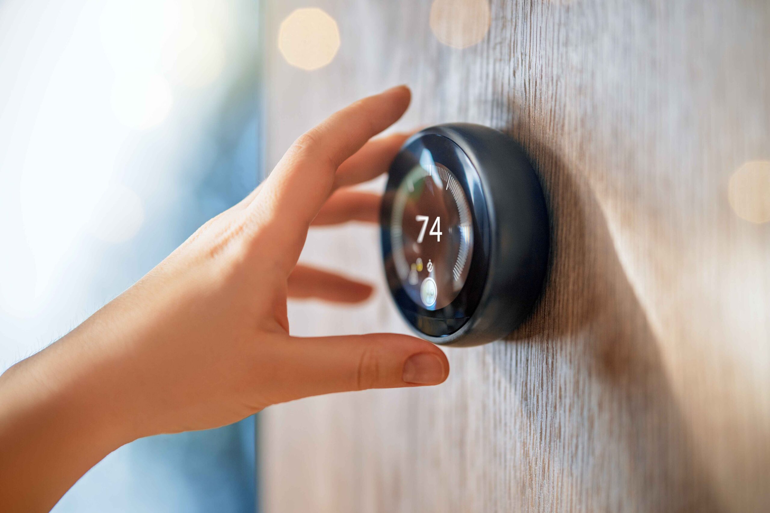 Hand reaching for thermostat