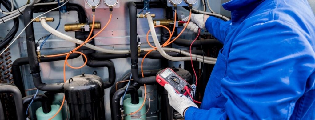 An HVAC technician working on a commercial air conditioning unit.